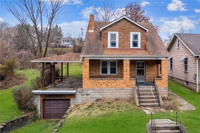 view of front of house with a garage, a front yard, and a porch