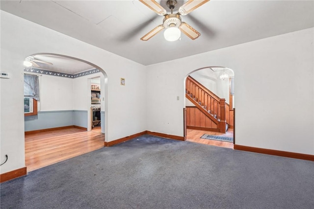 empty room featuring carpet floors and ceiling fan