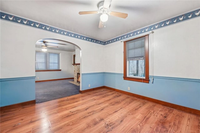 spare room featuring ceiling fan, plenty of natural light, and light hardwood / wood-style floors