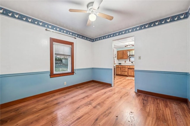 spare room featuring light hardwood / wood-style floors and ceiling fan