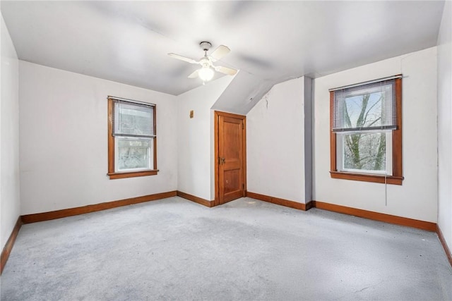 bonus room featuring lofted ceiling, light carpet, and ceiling fan