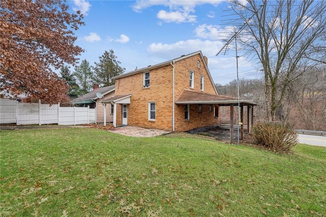 rear view of house with a lawn