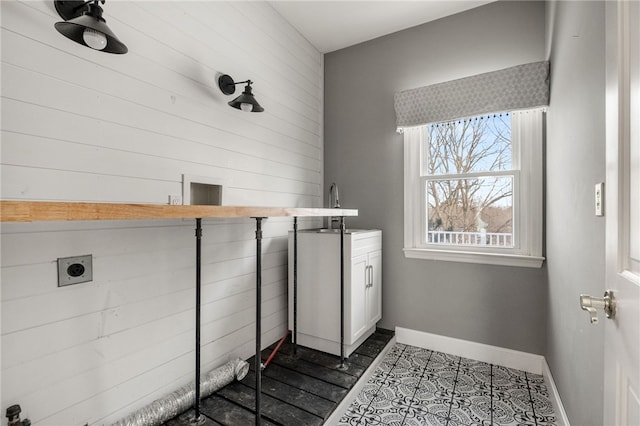 clothes washing area with cabinets, dark tile patterned floors, and electric dryer hookup