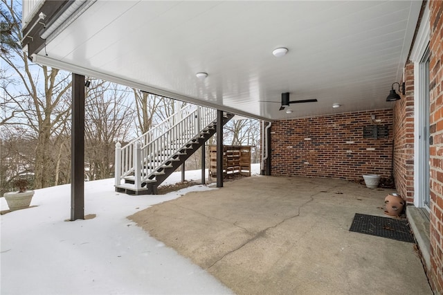 snow covered patio featuring ceiling fan