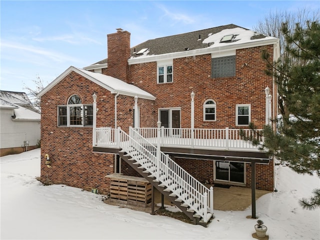 snow covered property featuring a wooden deck