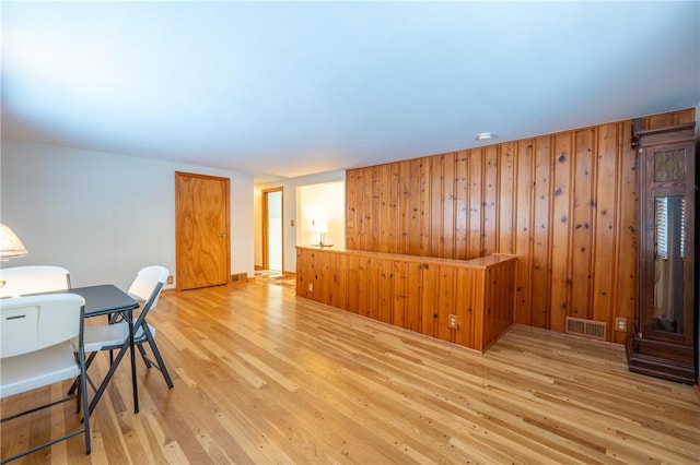 office area featuring wood walls and light wood-type flooring