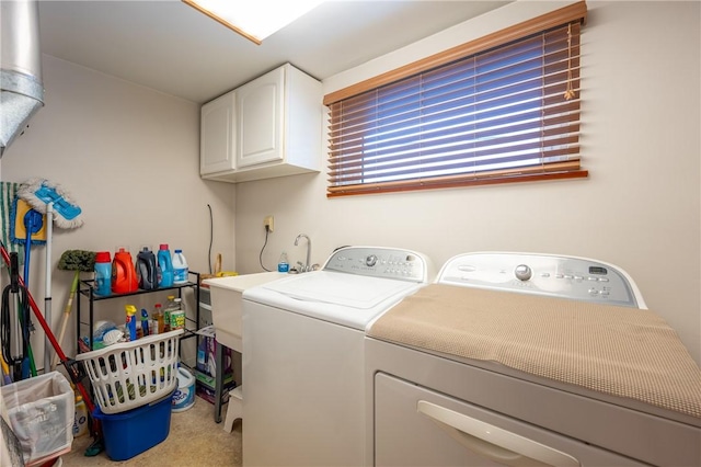 washroom with cabinets, light colored carpet, and washing machine and clothes dryer