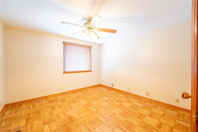 empty room featuring light parquet floors and ceiling fan