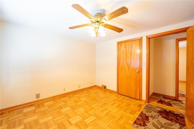 unfurnished bedroom featuring light parquet floors and ceiling fan