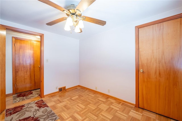 spare room with ceiling fan and light parquet floors