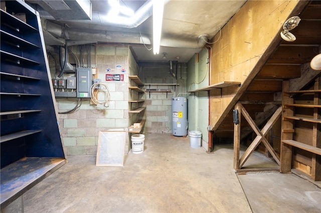 basement featuring water heater and electric panel