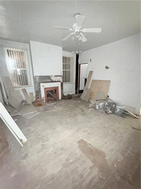 unfurnished living room featuring ceiling fan