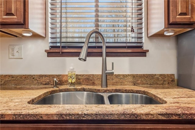 room details featuring sink and stone counters