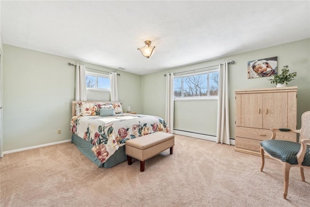 carpeted bedroom with a baseboard heating unit