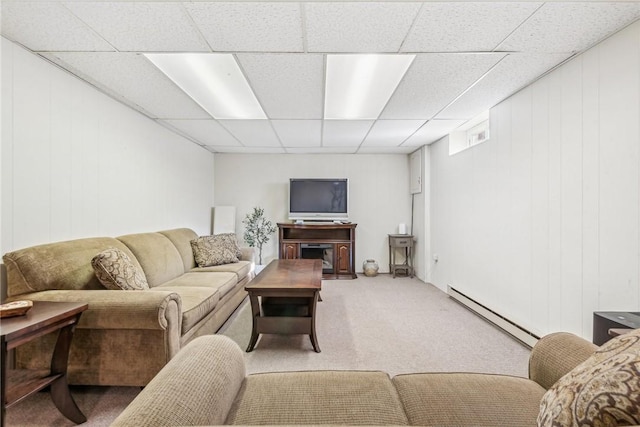 living room featuring a baseboard radiator, a paneled ceiling, and carpet flooring