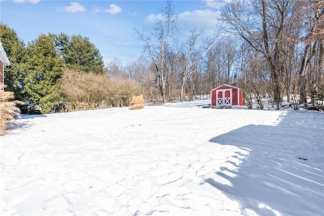 yard layered in snow with a storage unit