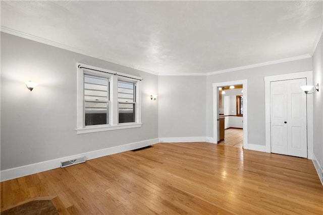 unfurnished room with crown molding and light hardwood / wood-style flooring