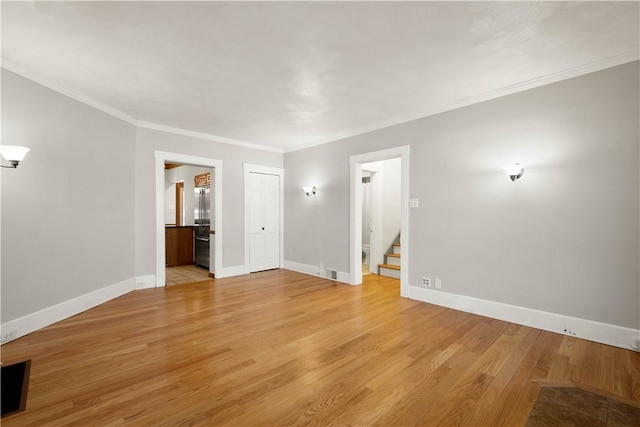 spare room with light hardwood / wood-style flooring and ornamental molding