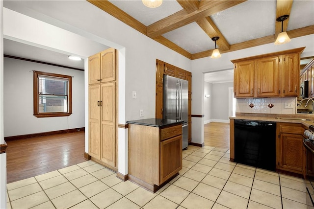 kitchen featuring tasteful backsplash, stainless steel appliances, hanging light fixtures, and light tile patterned floors