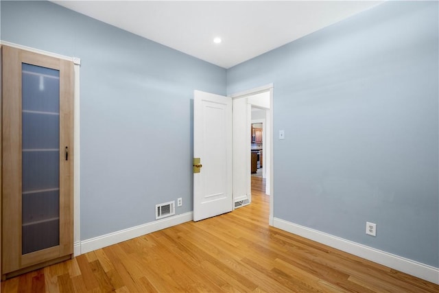 spare room featuring light hardwood / wood-style flooring