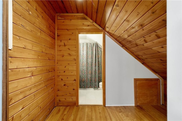 additional living space featuring lofted ceiling, light hardwood / wood-style flooring, and wooden ceiling