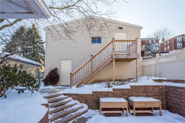 view of snow covered rear of property