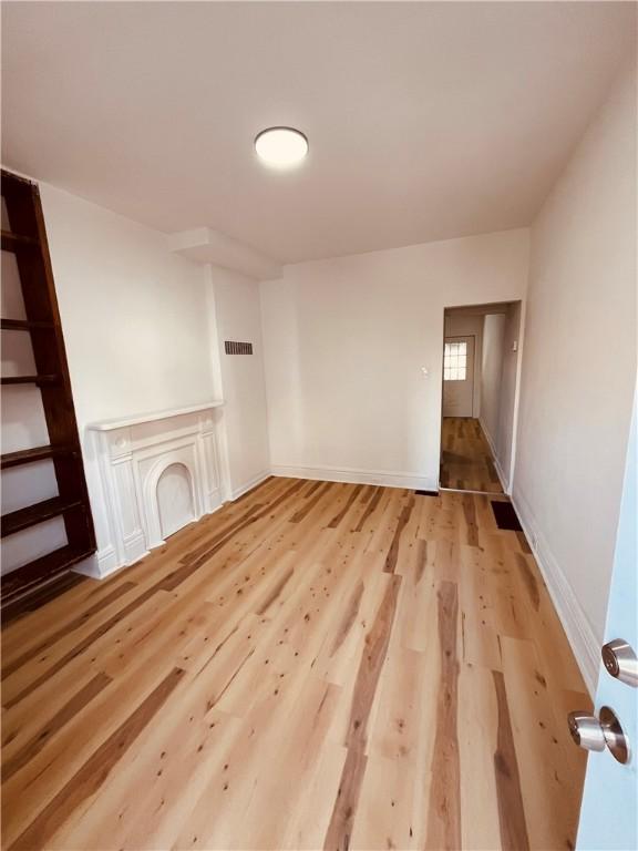 unfurnished living room with light hardwood / wood-style flooring