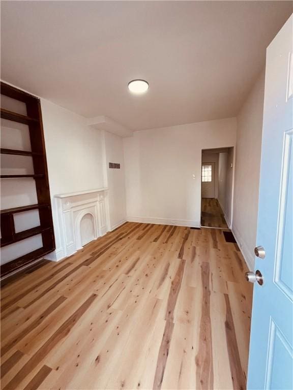 unfurnished living room featuring light hardwood / wood-style flooring