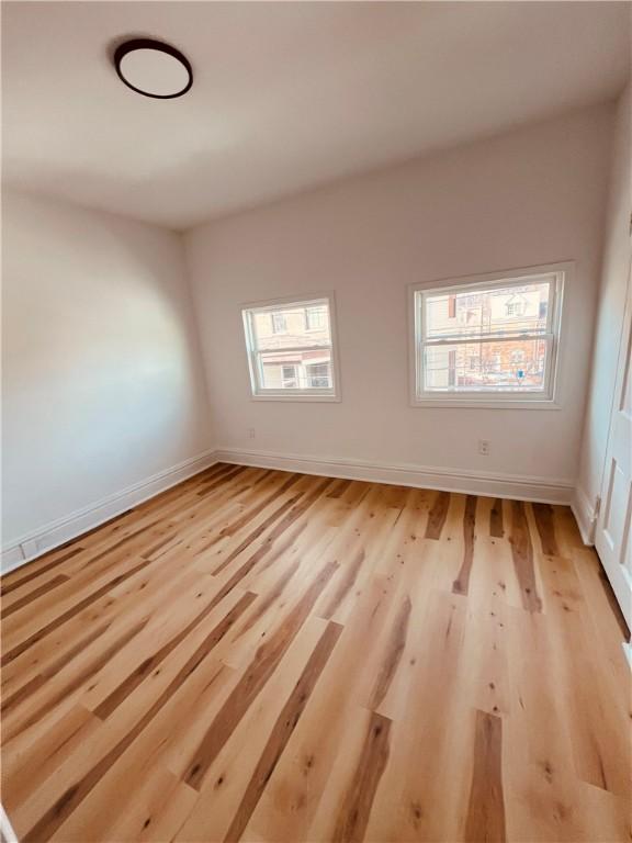 unfurnished room featuring plenty of natural light and light hardwood / wood-style flooring