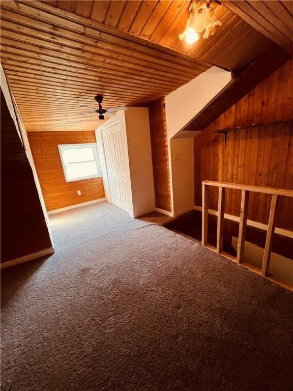 additional living space featuring wood ceiling, ceiling fan, carpet, vaulted ceiling, and wood walls