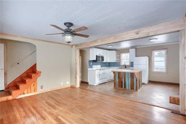 kitchen featuring sink, white cabinetry, crown molding, light wood-type flooring, and white appliances