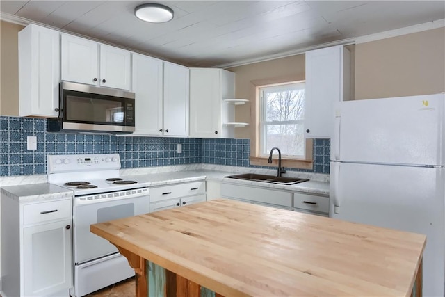 kitchen with white cabinetry, sink, and white appliances