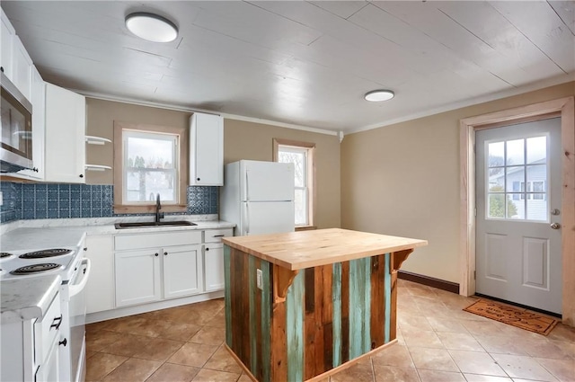 kitchen with sink, plenty of natural light, white cabinets, white appliances, and backsplash