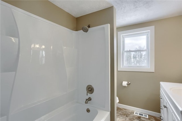 full bathroom with  shower combination, toilet, a textured ceiling, and vanity