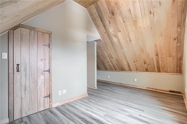 additional living space with lofted ceiling and light wood-type flooring