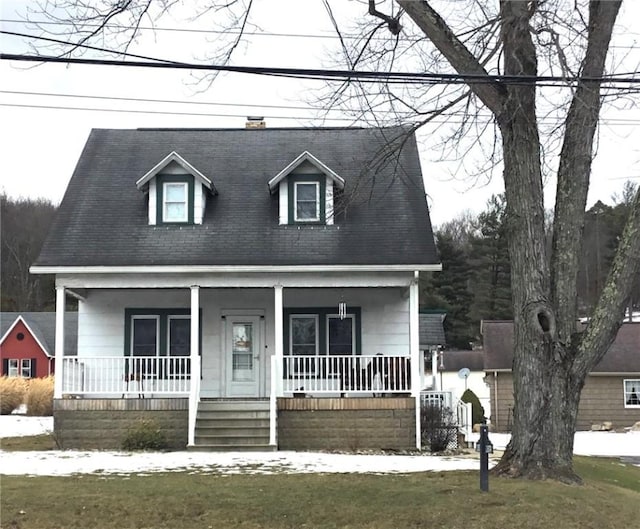 new england style home featuring covered porch