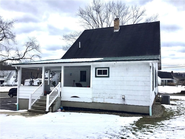 snow covered property featuring covered porch