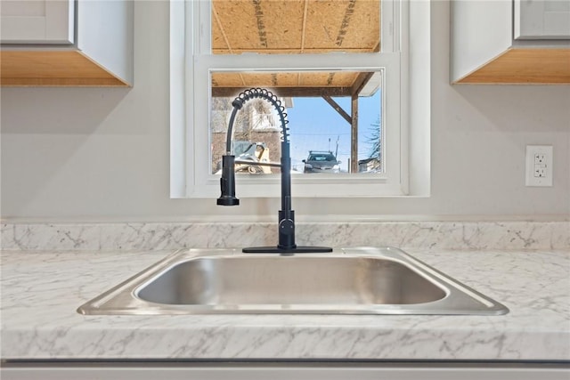 interior details with sink and white cabinets