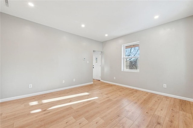 spare room featuring light hardwood / wood-style flooring