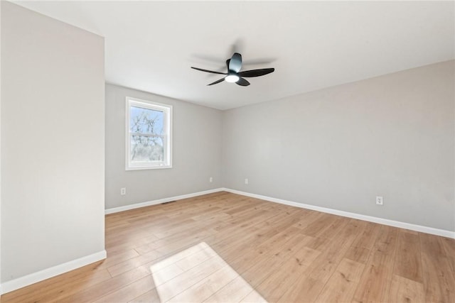 empty room with ceiling fan and light wood-type flooring