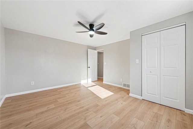 unfurnished bedroom featuring a closet, ceiling fan, and light wood-type flooring