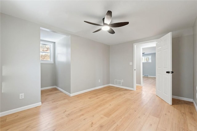 unfurnished room featuring ceiling fan, plenty of natural light, and light hardwood / wood-style floors