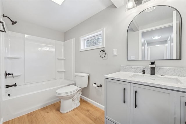 full bathroom with vanity, wood-type flooring, tub / shower combination, and toilet