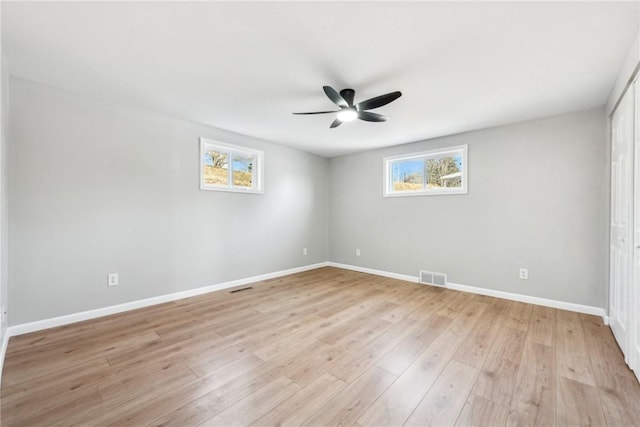 unfurnished room featuring ceiling fan, light hardwood / wood-style floors, and a wealth of natural light