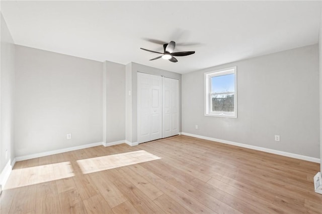 unfurnished bedroom with ceiling fan and light wood-type flooring