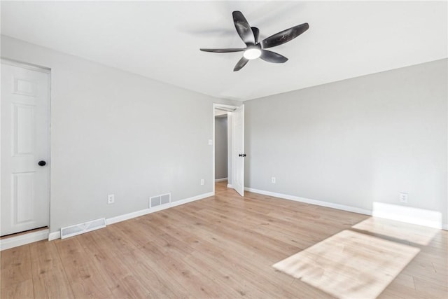 empty room with ceiling fan and light wood-type flooring