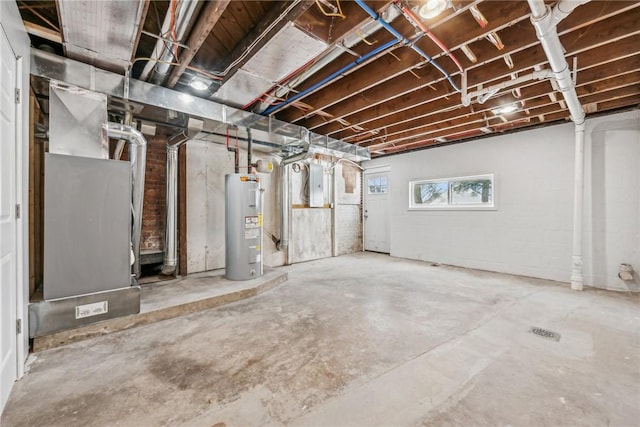 basement featuring heating unit, electric panel, and water heater