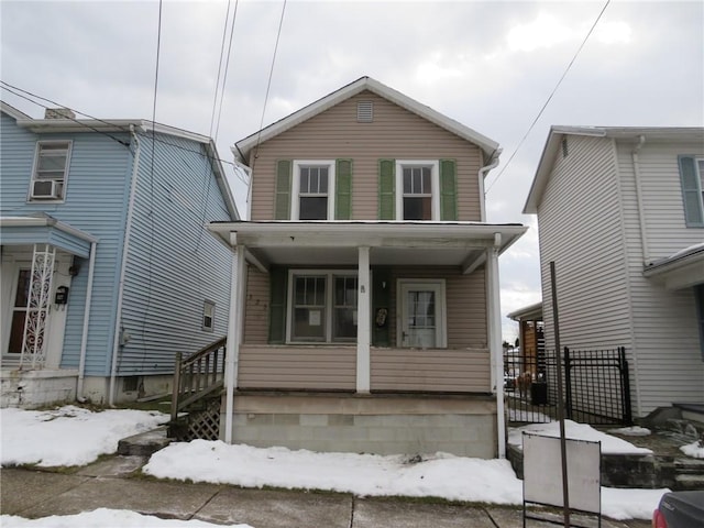 view of front of house with cooling unit and a porch