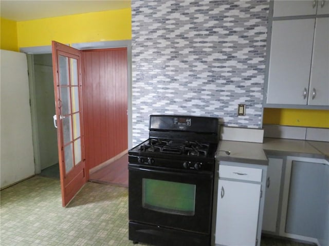 kitchen featuring dark countertops and black gas range oven