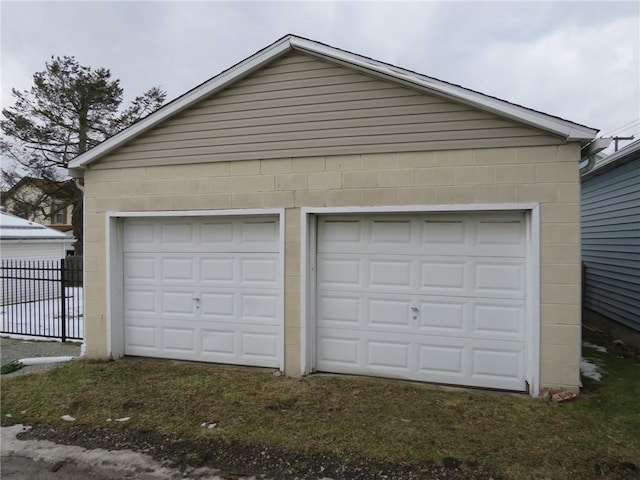 detached garage featuring fence